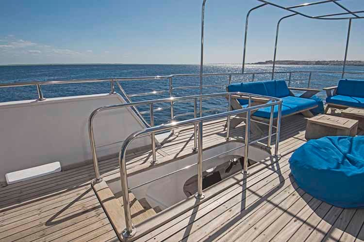 Table and chairs on deck of a luxury motor yacht