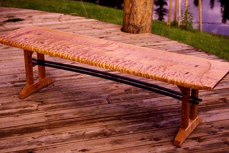 carved bench made of highly-figured maple.
